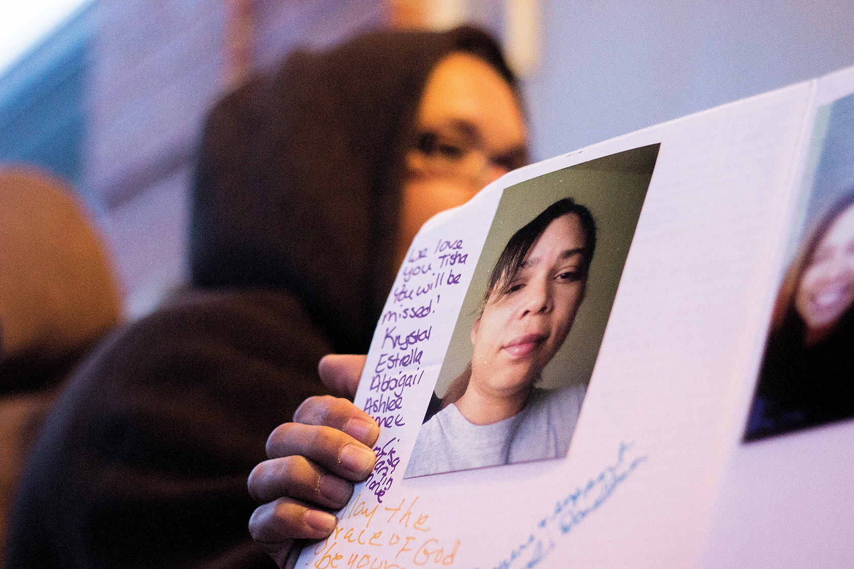 Friends and family sign a poster board in Letitia Davis's memory Sunday. (Photo by Kevin Brown)